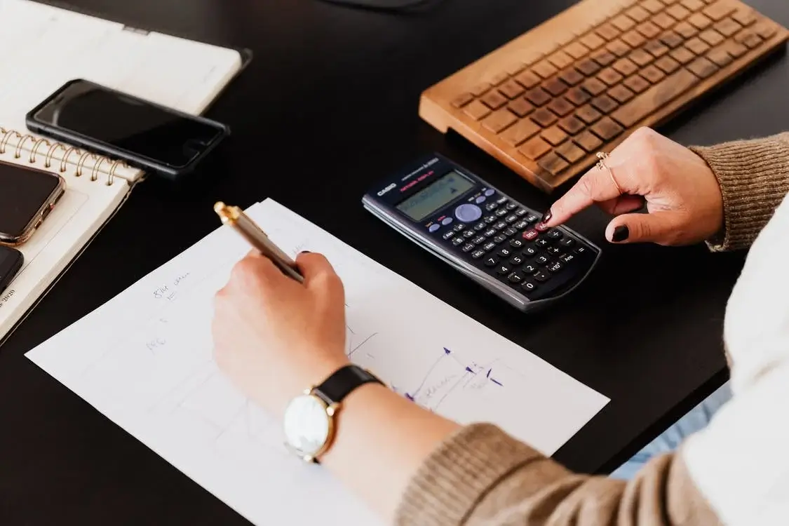 Using a calculator to complete tax forms as a side hustle