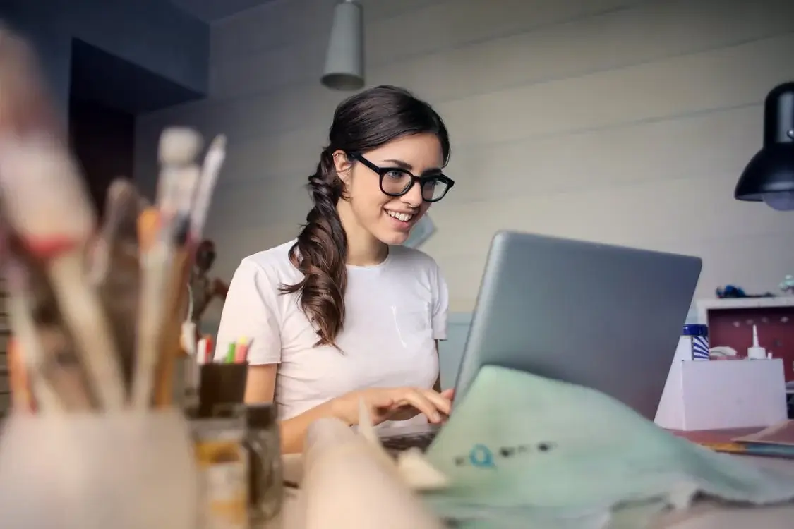 Sitting behind a laptop creating an online course