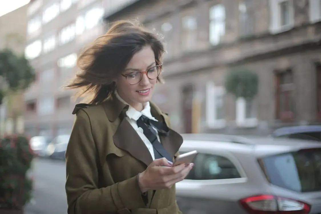 Woman walking using her phone