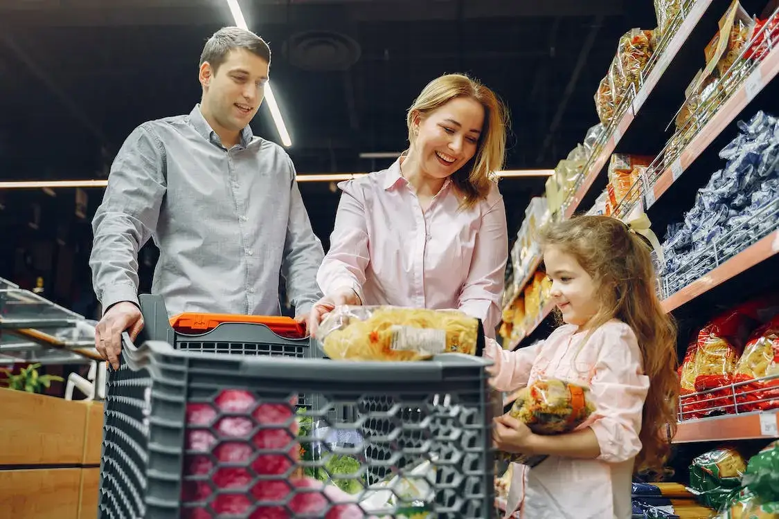 teaching a kid about comparing food prices in a supermarket