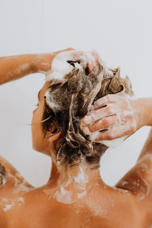taking a shorter shower to save money on water using the navy shower method